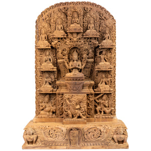 Woodcarving from Bungmati, Nepal. Shadakshari Lokeshvara (the Lord of the Six Syllabes) is a manifestation of Avalokiteshvara, the Bodhisattva a of Compassion. This magnificent relief on Magnolia Champaca is a slightly modified replica of a relief, which won the Nepalese National Fine Arts Prize in 2020. This statue was part of the exhibition: "The Revival of Newari Woodcarving, 2024".