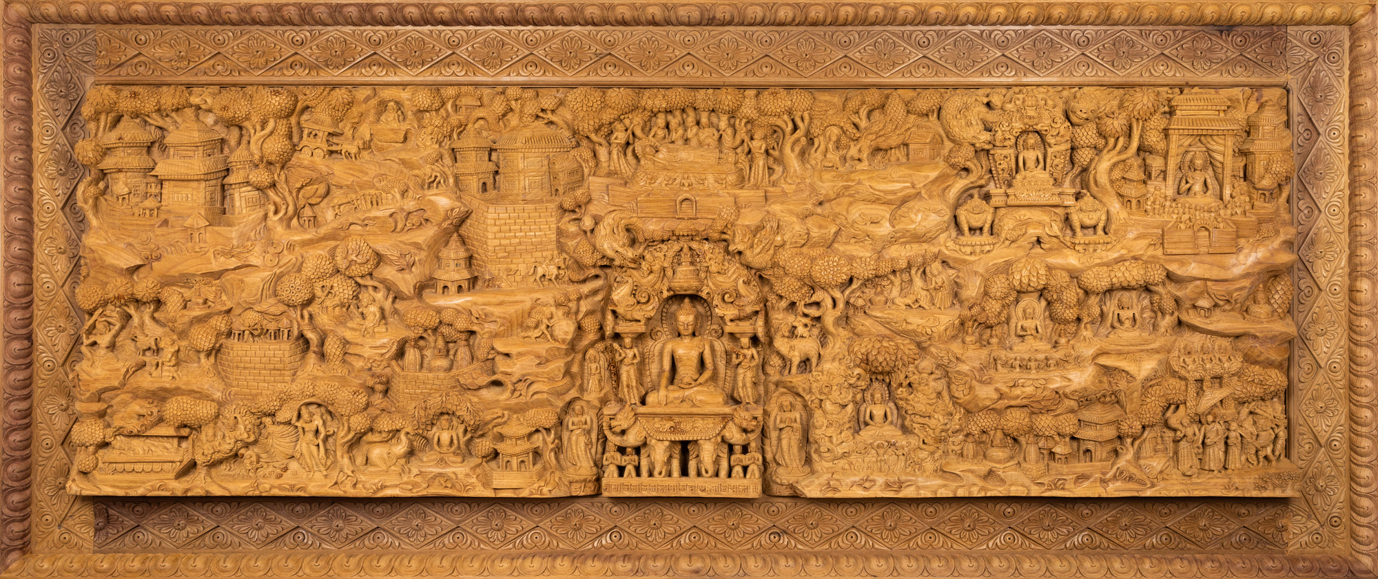 Woodcarving from Nepal. This impressive piece carved in one single piece of wood (Magnolia Champaca) describes in much detail the life of the Buddha Siddartha Gautama.
This panoramic relief is a modified and improved replica of a previous version, which won the Fine Arts Special award in 2022 (amongst all categories of traditional statues).This statue was part of the exhibition in the Patan Museum: "The Revival of Newari Woodcarving, 2024".