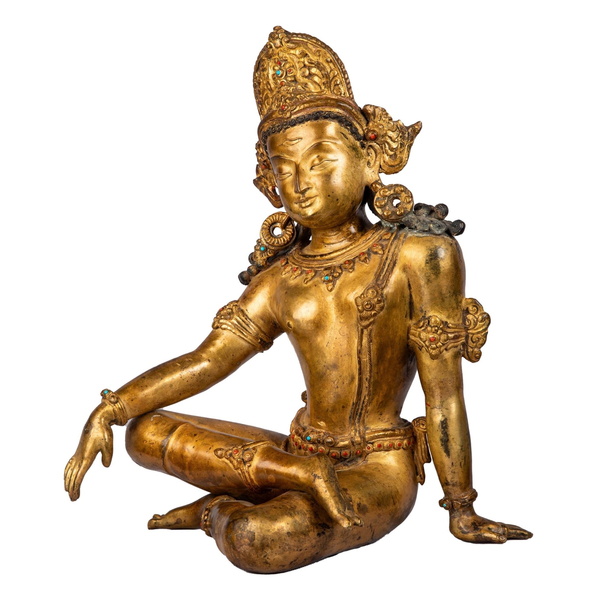 Left side view showing relaxed royal pose and jewelled ornaments.