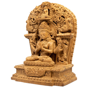 Left side view showing rosary (mālā) and carved ornaments.