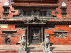 Entrance of Yetakha Baha Temple in Kathmandu, Nepal, featuring its historic medieval wooden torana.